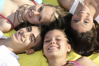 teens laying in circle on the ground